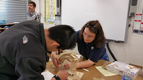 Antigone Sharris, see here with a student from Leyden High School, volunteered to sponsor an SCC event at Triton College.