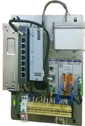 Figure 3. The Pinfabb ship stabilizer control panel, showing the RMC75E motion controller at right. Also shown from the left are the 24-Vdc power supply (used to power the RMC75 and the proportional valves), an Ethernet switch (used to connect the RMC75 and the automation panels with the industrial PC), and a 12-Vdc and 5-Vdc power supply (used to power the fin angle feedback and acceleration sensors). Above the RMC is the angular acceleration sensor that is used to monitor the ship’s movement.